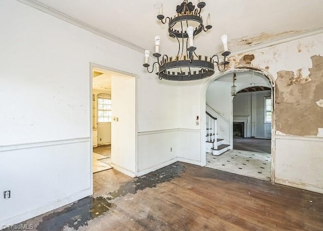 unfurnished dining area with hardwood / wood-style flooring and ornamental molding