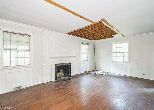 unfurnished living room featuring dark hardwood / wood-style floors and crown molding