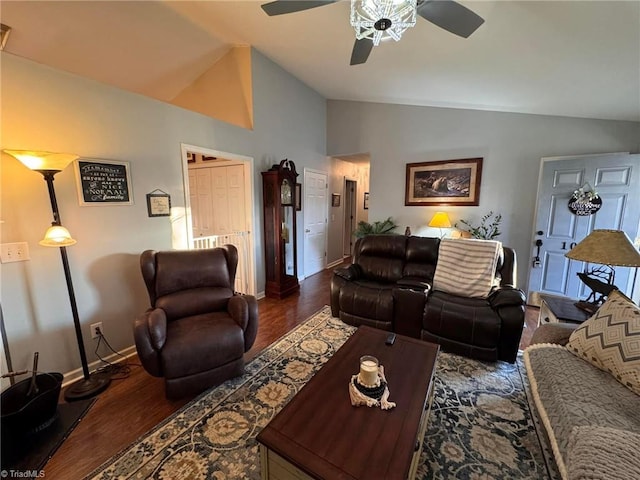 living room with ceiling fan, lofted ceiling, and dark hardwood / wood-style floors