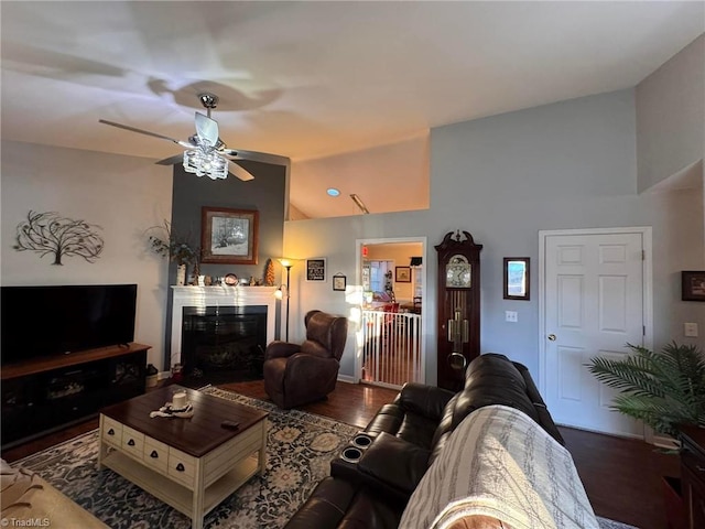 living room with lofted ceiling, dark wood-type flooring, and ceiling fan