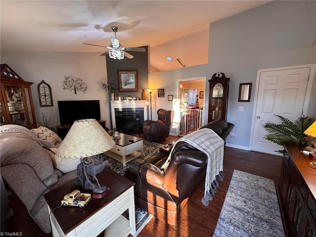 living room featuring vaulted ceiling, dark wood-type flooring, and ceiling fan