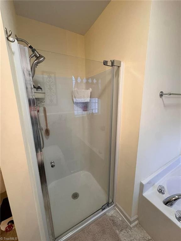 bathroom with plus walk in shower and tile patterned flooring