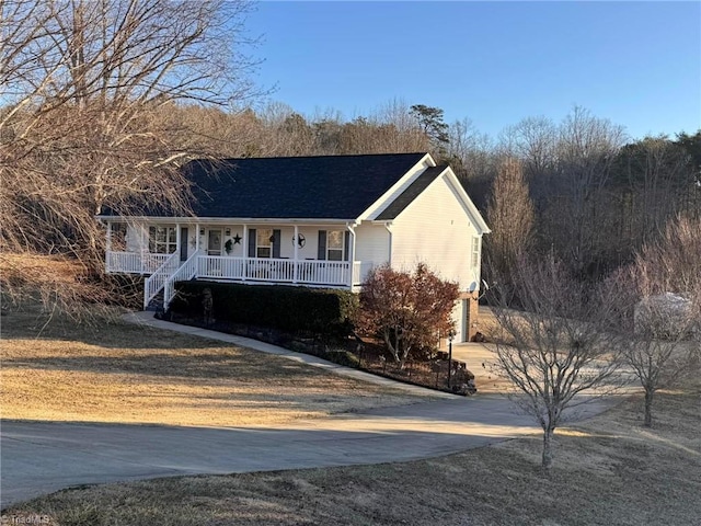 single story home featuring a garage and covered porch