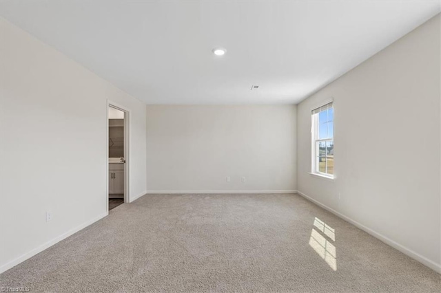 carpeted empty room with baseboards