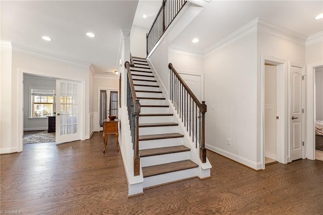 stairway featuring ornamental molding and wood-type flooring