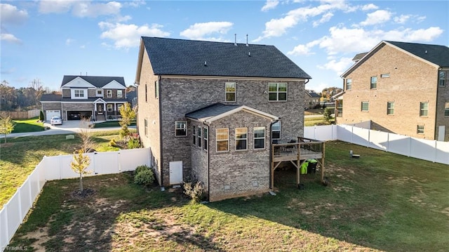 back of house with a yard and a wooden deck