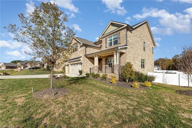 view of front of house with a front lawn, a garage, and covered porch