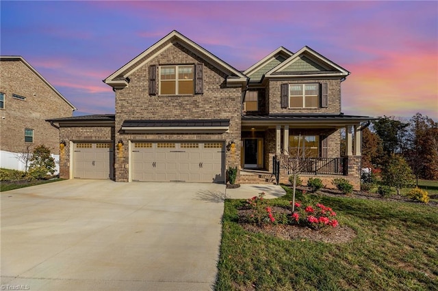 craftsman inspired home with a garage, a porch, and a yard