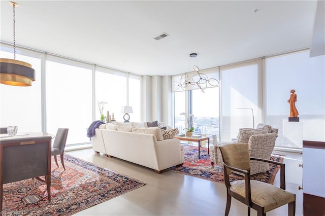 living room featuring expansive windows and a baseboard heating unit