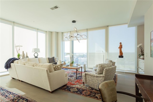 living room with a notable chandelier and floor to ceiling windows