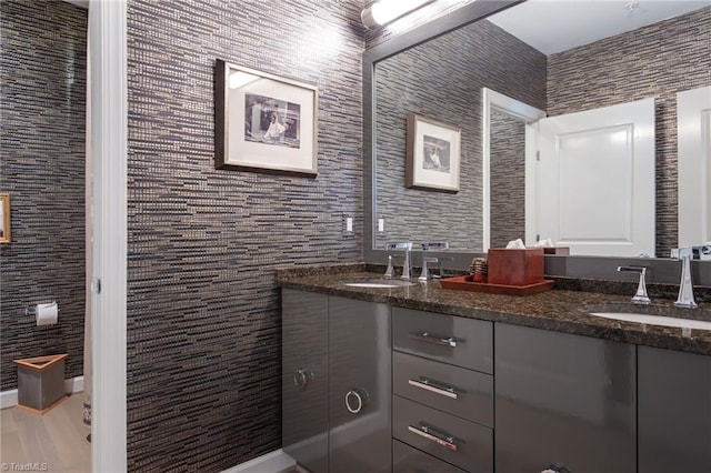 bathroom featuring hardwood / wood-style floors, vanity, and tile walls