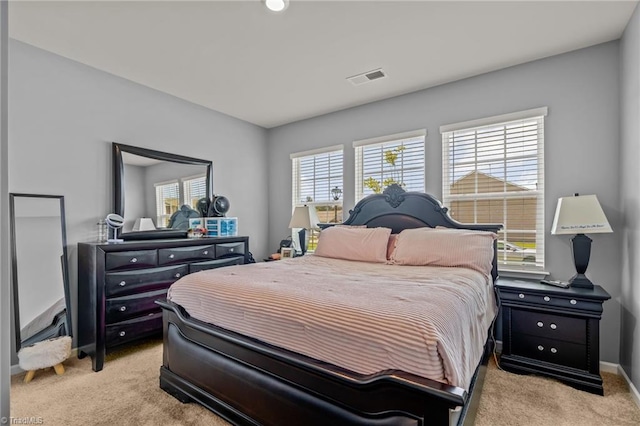 bedroom with light carpet and visible vents