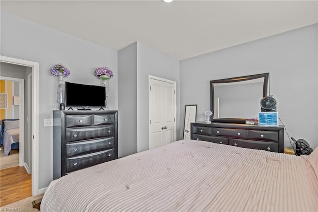 bedroom with a closet and baseboards