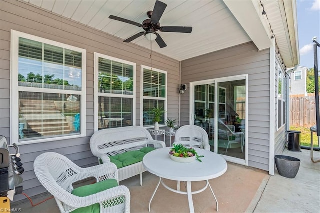 view of patio featuring ceiling fan and fence