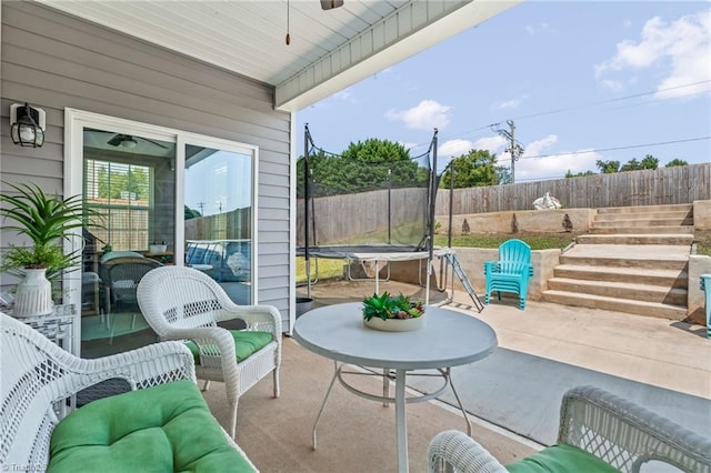 view of patio / terrace featuring a trampoline and a fenced backyard