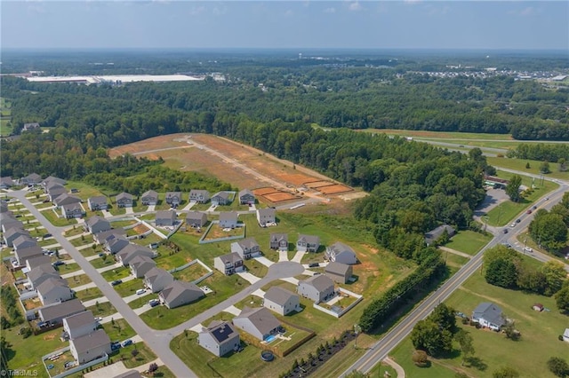 bird's eye view featuring a forest view and a residential view