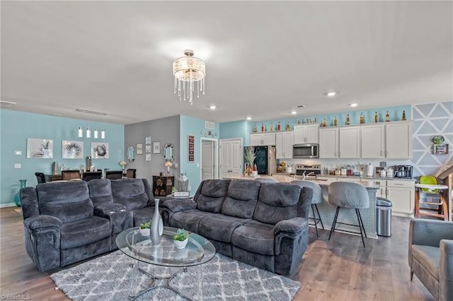 living area with wood finished floors and recessed lighting