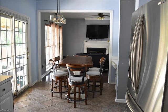 1030 Still Point Dr, Winston-Salem, NC 27103 - dining area with ceiling fan, a fireplace, tile patterned flooring, and baseboards