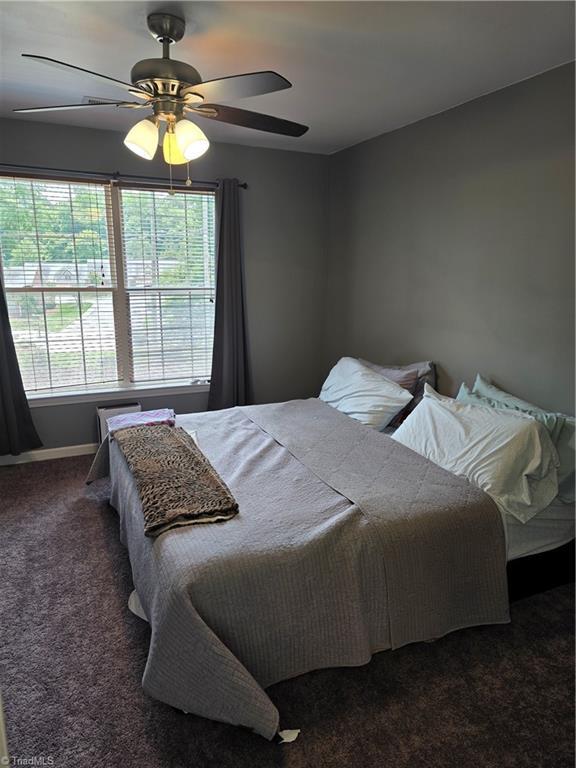1030 Still Point Dr, Winston-Salem, NC 27103 - carpeted bedroom with ceiling fan and baseboards