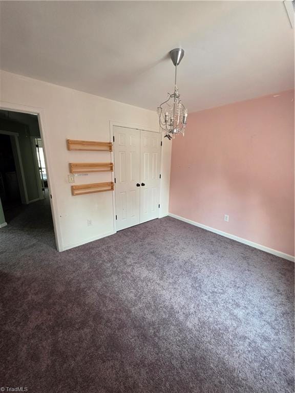 1030 Still Point Dr, Winston-Salem, NC 27103 - unfurnished dining area featuring dark carpet, a chandelier, and baseboards