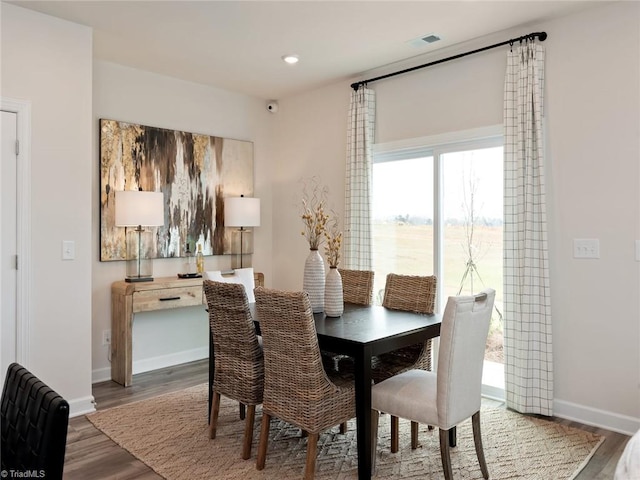 dining space with hardwood / wood-style flooring