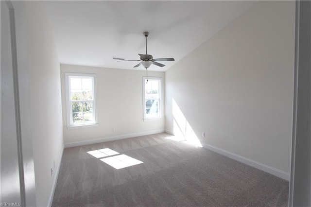 spare room with vaulted ceiling, ceiling fan, and carpet floors