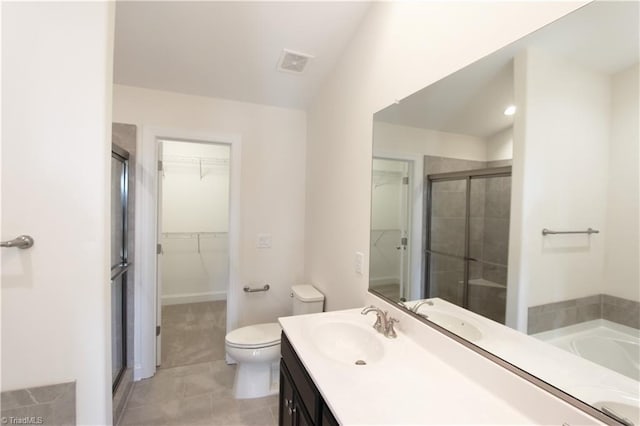 full bathroom featuring tile flooring, large vanity, plus walk in shower, and toilet