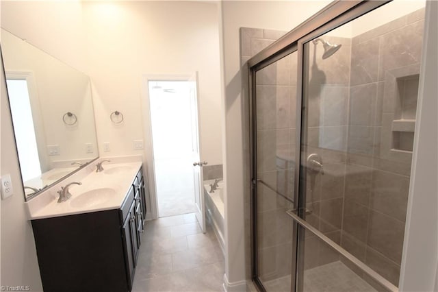 bathroom with vanity with extensive cabinet space, separate shower and tub, dual sinks, and tile flooring