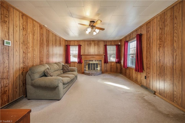 living room with carpet flooring, plenty of natural light, ceiling fan, and a brick fireplace