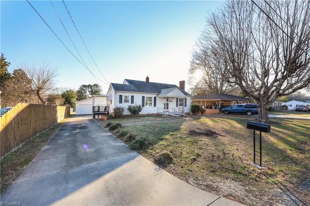 view of front of home with a garage and an outdoor structure