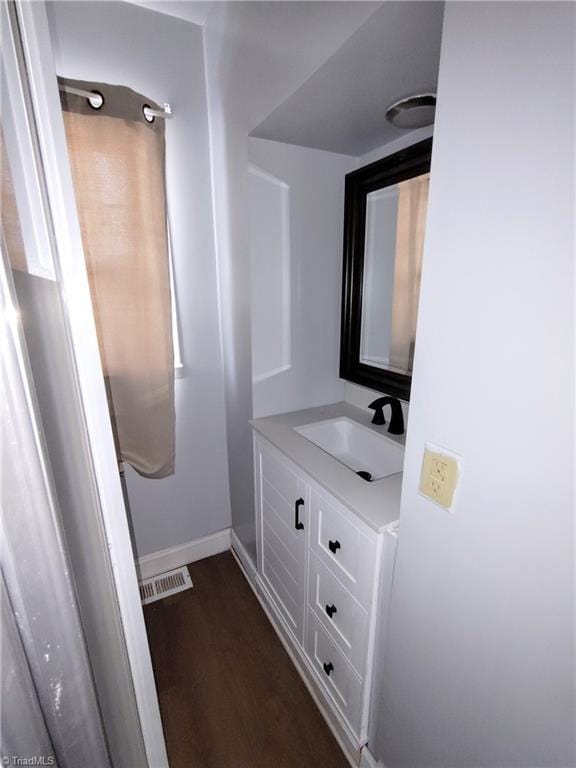 bathroom with vanity and wood-type flooring