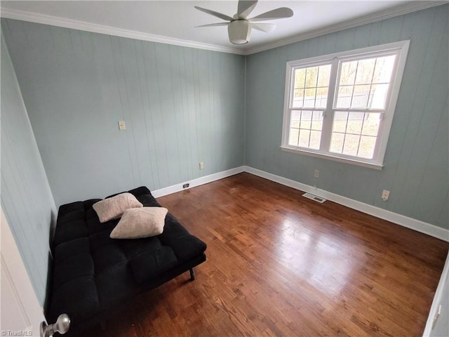 sitting room featuring ceiling fan, ornamental molding, and hardwood / wood-style floors