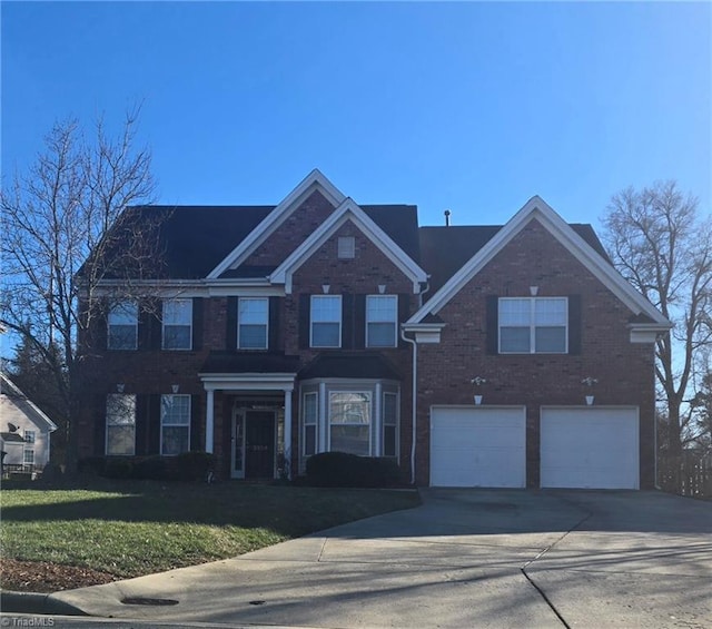 view of front of house featuring a front yard and a garage