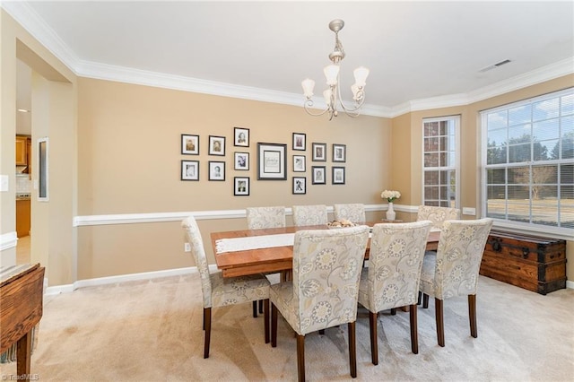 dining space featuring a notable chandelier, light colored carpet, and ornamental molding