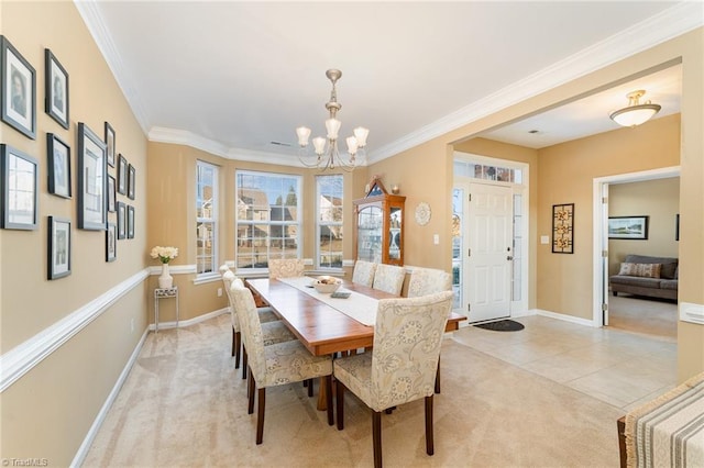 carpeted dining area featuring a chandelier and ornamental molding