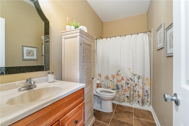 bathroom featuring tile patterned flooring, vanity, and toilet