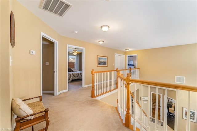 hallway with light colored carpet