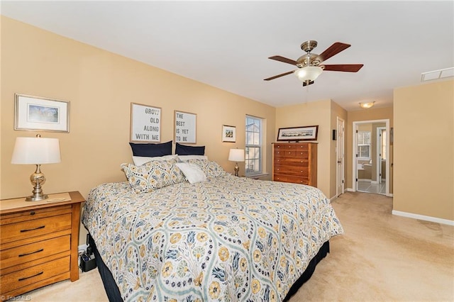 carpeted bedroom featuring ceiling fan and ensuite bathroom