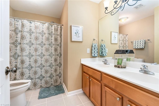 bathroom featuring tile patterned flooring, vanity, toilet, and an inviting chandelier