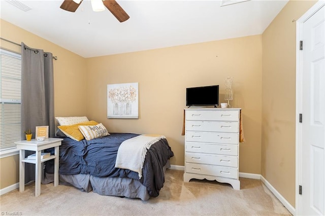 bedroom with ceiling fan and light colored carpet