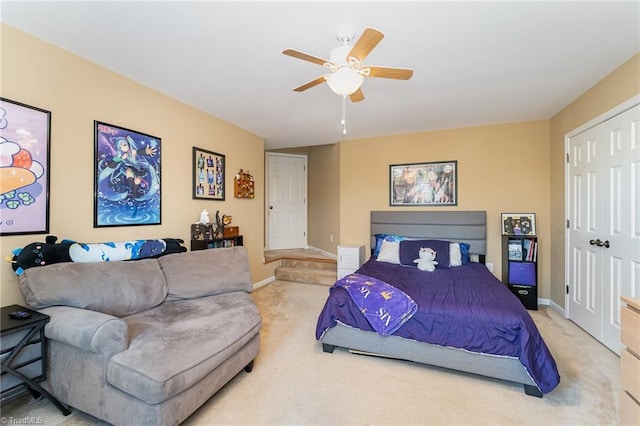 bedroom with ceiling fan, a closet, and light carpet