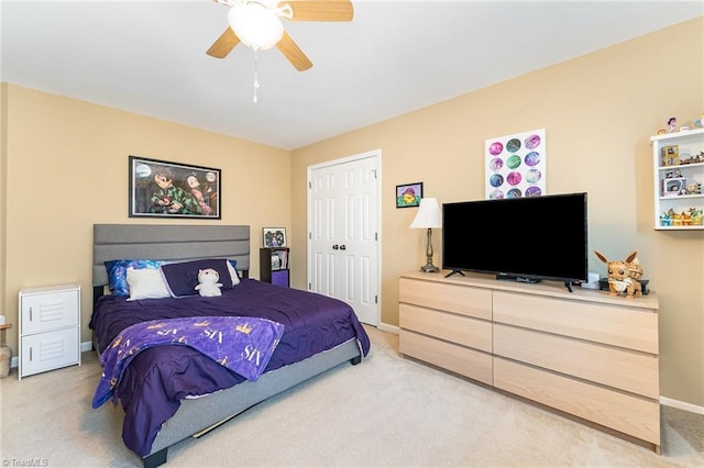 bedroom featuring ceiling fan, light colored carpet, and a closet