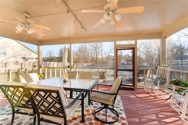 sunroom / solarium featuring ceiling fan and plenty of natural light