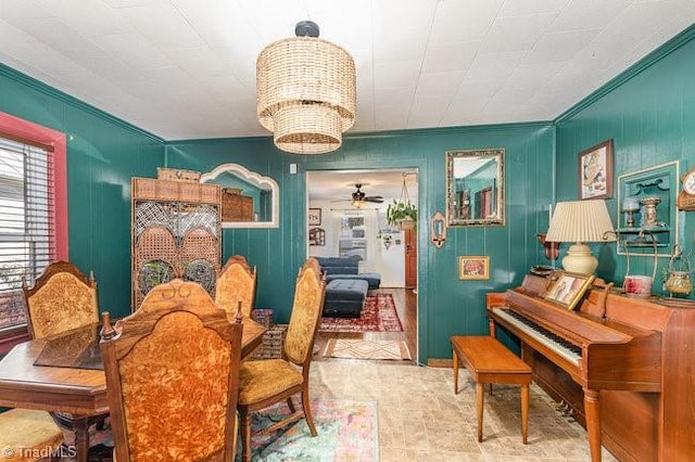 interior space with ceiling fan with notable chandelier and crown molding