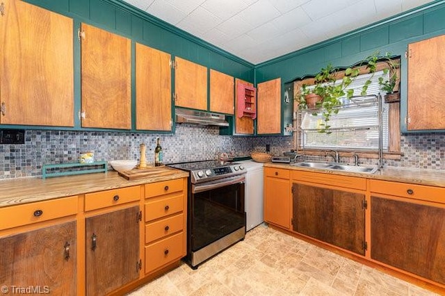 kitchen featuring sink, backsplash, stainless steel range, and ornamental molding