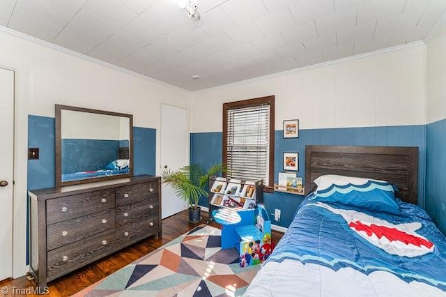 bedroom featuring dark hardwood / wood-style flooring and ornamental molding