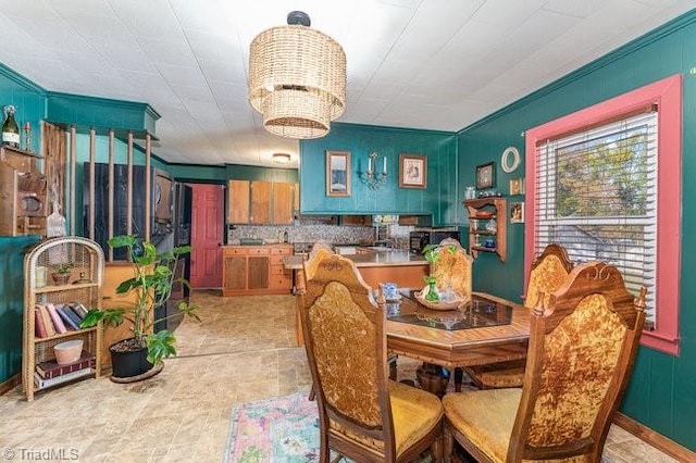 dining room featuring ornamental molding and a chandelier