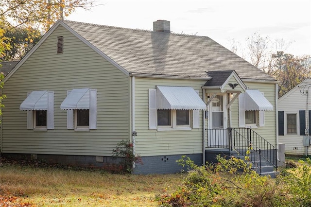 view of front of property featuring crawl space and a chimney