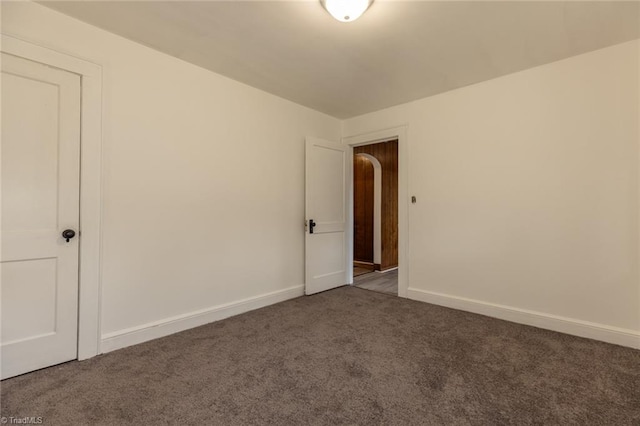 carpeted spare room with baseboards