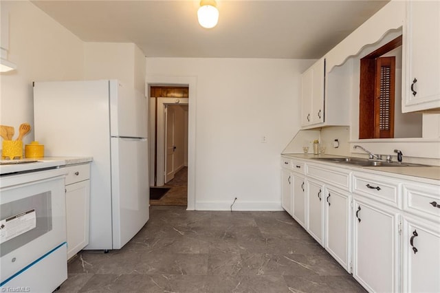 kitchen featuring white cabinetry, light countertops, and a sink